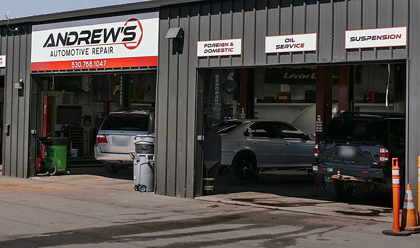 A minivan, a sedan, and an SUV in the service bays at Andrew's Automotive Repair in Redding